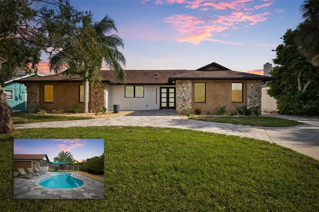 a front view of a house with swimming pool and yard