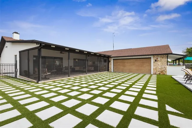 an aerial view of a house with yard
