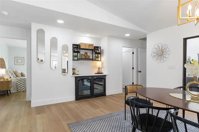 a living room with couch floor to ceiling windows and a table