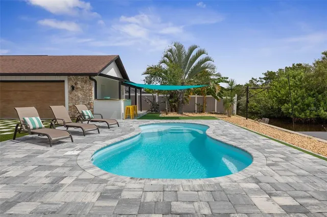 a kitchen with granite countertop a refrigerator and a sink