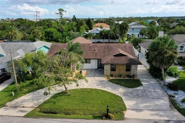 a view of a house with swimming pool and sitting area