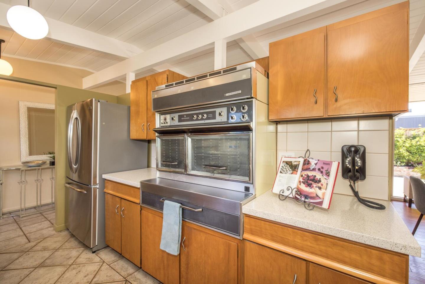 1619 Celeste Drive San Mateo, CA 94402 - Photo 18 of 44 a kitchen with stainless steel appliances kitchen island granite countertop a refrigerator and a stove