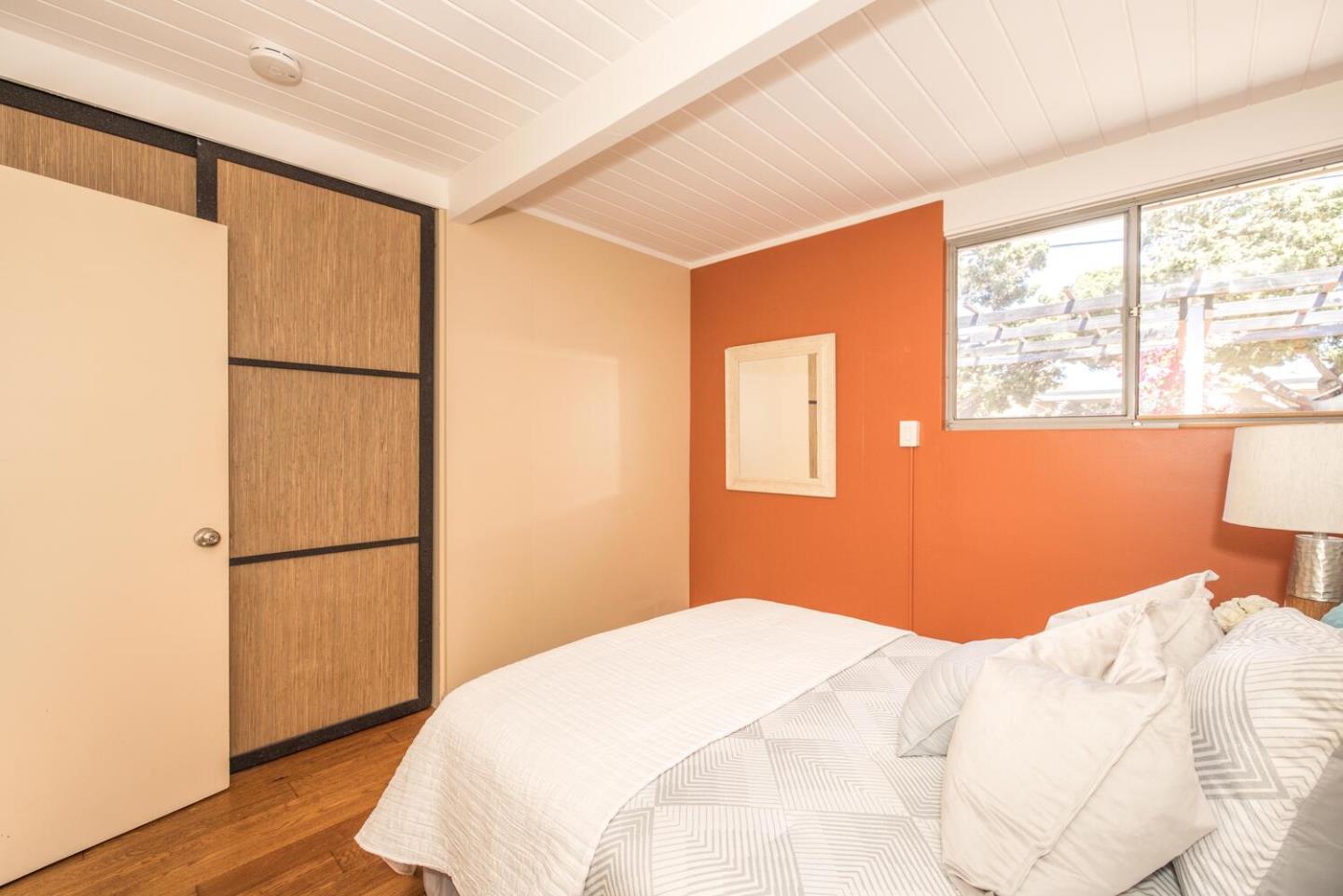 1619 Celeste Drive San Mateo, CA 94402 - Photo 28 of 44 a bedroom with a bed and a refrigerator