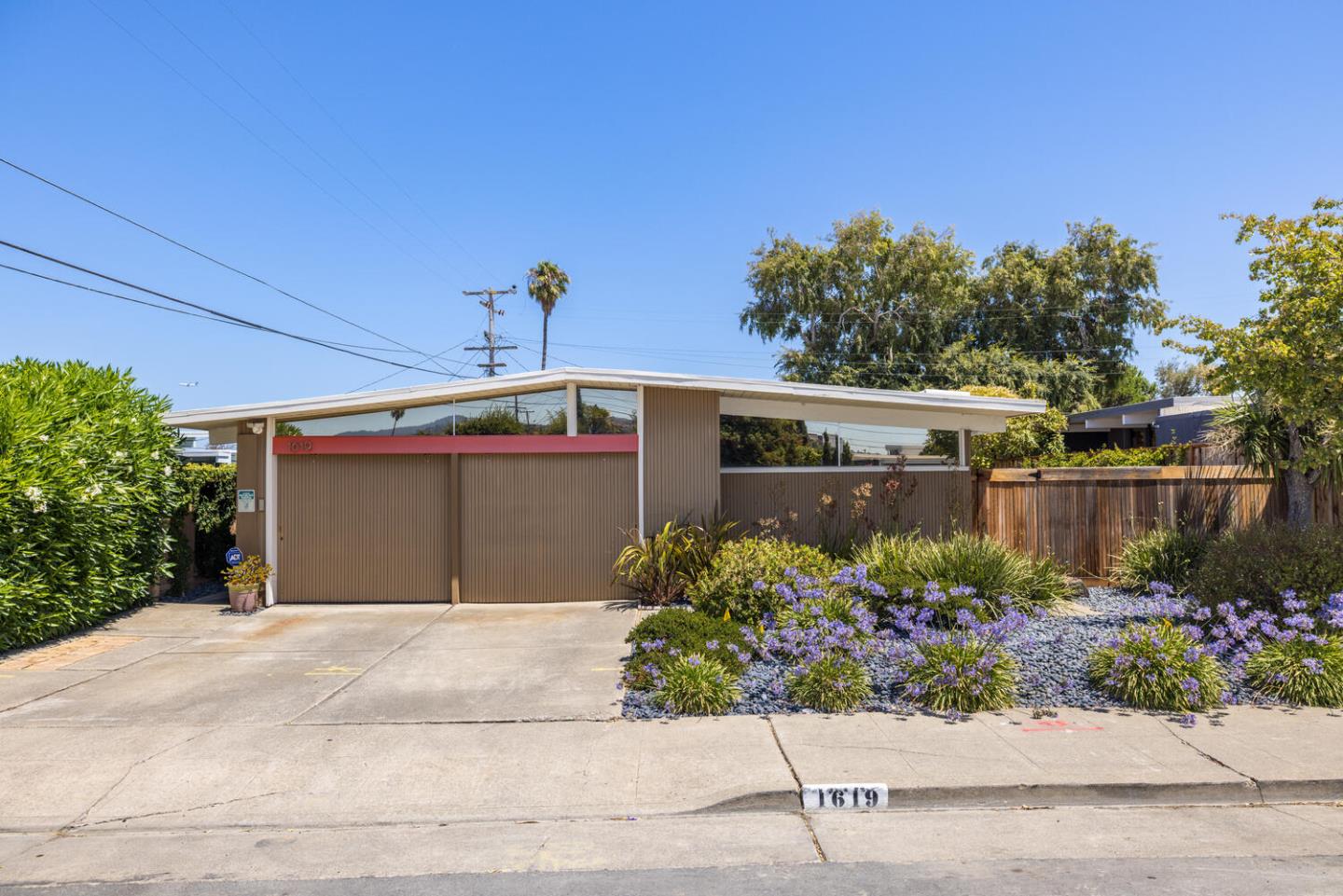 1619 Celeste Drive San Mateo, CA 94402 - Photo 3 of 44 a front view of a house with a yard and a garage