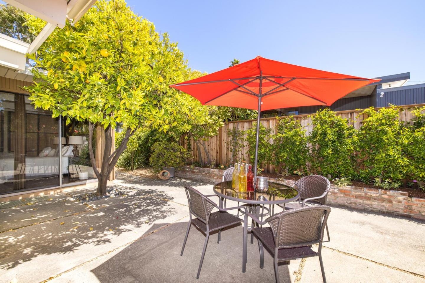 1619 Celeste Drive San Mateo, CA 94402 - Photo 37 of 44 a patio with a table and chairs under an umbrella