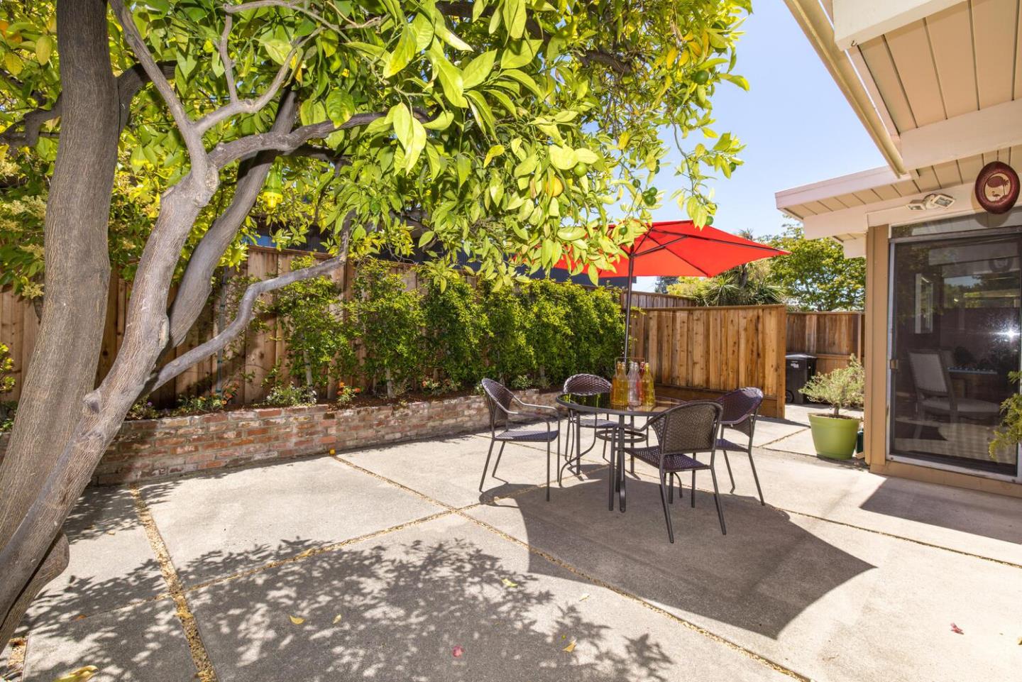 1619 Celeste Drive San Mateo, CA 94402 - Photo 38 of 44 a view of a patio with a table and chairs under an umbrella