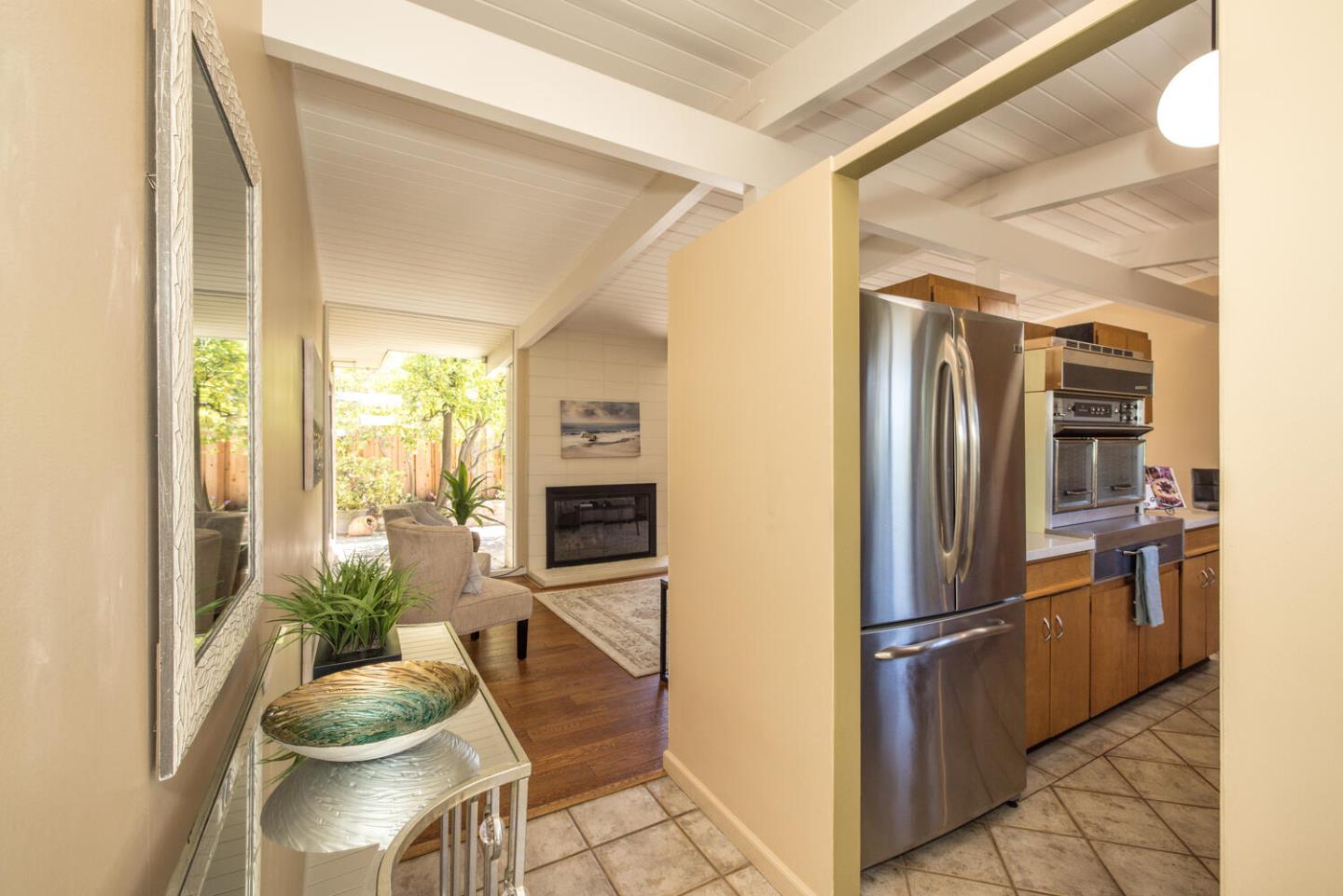 1619 Celeste Drive San Mateo, CA 94402 - Photo 6 of 44 a kitchen with stainless steel appliances kitchen island granite countertop a refrigerator a stove and a sink with granite countertops