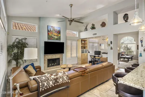 a living room with furniture a flat screen tv and a fireplace