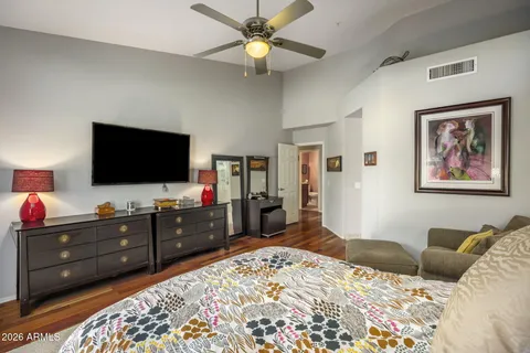 a bedroom with a bed and a flat screen tv