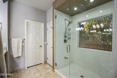 a bathroom with a glass shower door