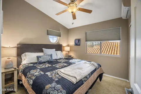 a bathroom with a granite countertop sink toilet and mirror