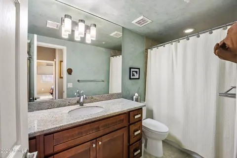 a bedroom with two beds and a chandelier