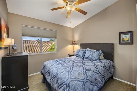 a backyard of a house with fountain table and chairs