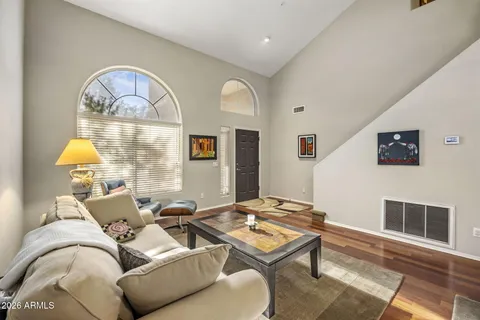 a living room with furniture fireplace and a table