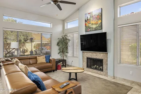 a living room with furniture a flat screen tv and a fireplace