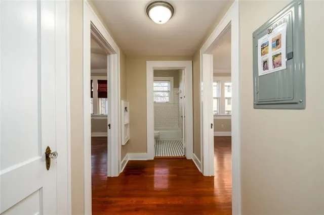 a view of a hallway with wooden floor and closet
