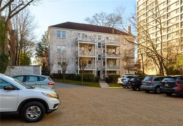 a car parked in front of a white house