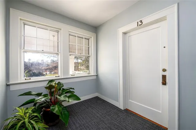 a room with window and a potted plant