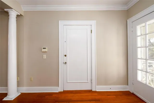 a view of room with window and wooden floor