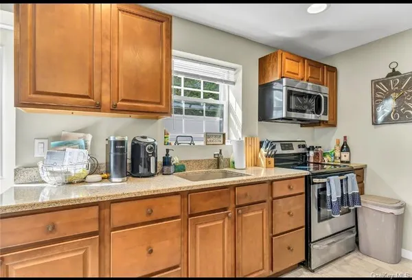 a kitchen with stainless steel appliances granite countertop a sink stove and cabinets