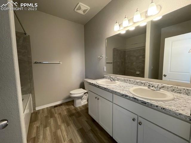 2931 Magic Carpet Loop Colorado Springs, CO 80916 - Photo 8 of 13 a bathroom with a granite countertop sink a toilet and a mirror