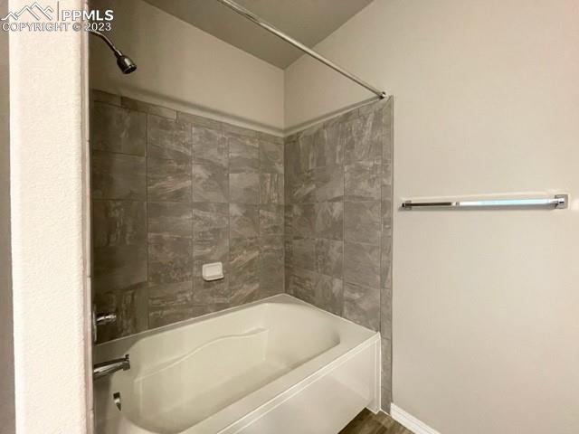 2931 Magic Carpet Loop Colorado Springs, CO 80916 - Photo 9 of 13 a bathroom with a tub and shower