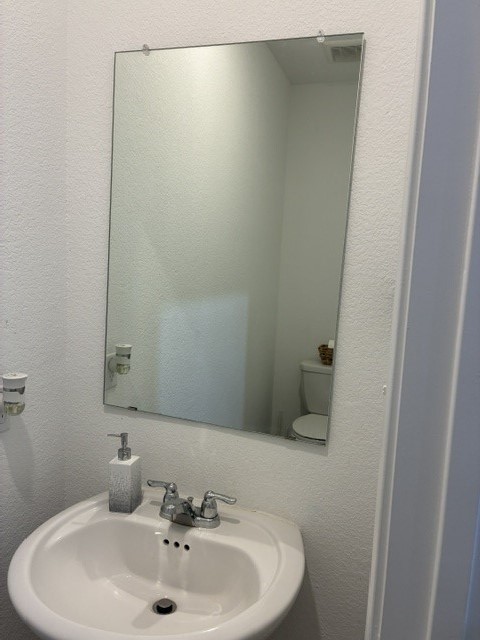 233 Perfect World Loop Jarrell, TX 76537 - Photo 8 of 24 A compact vanity with a gleaming sink and faucet awaits in this functional powder room.