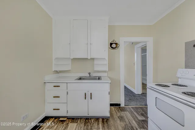 a kitchen with a stove and cabinets