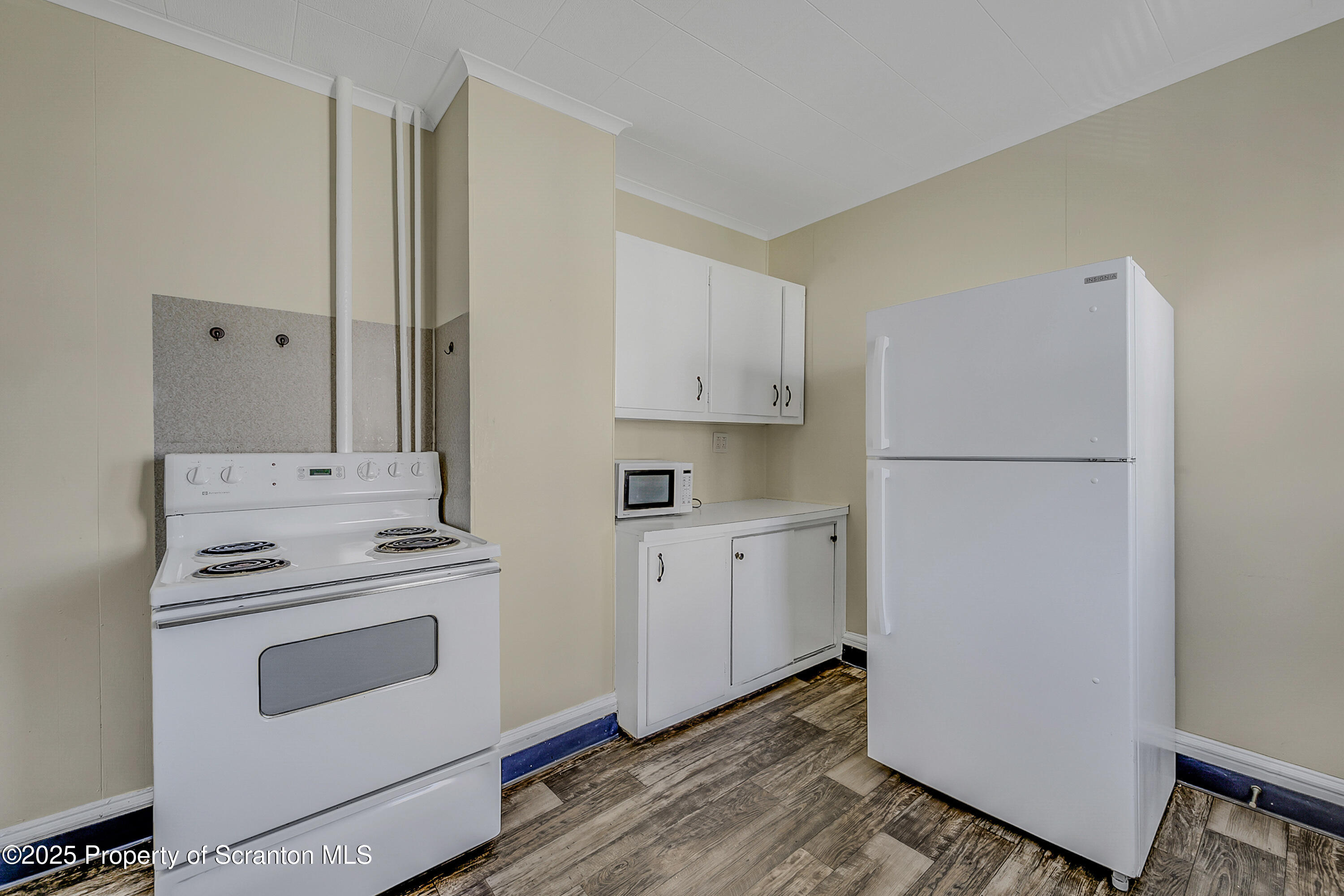 864 South Main Street, Unit 2 Old Forge, PA 18518 - Photo 5 of 14 a kitchen with white cabinets and white appliances