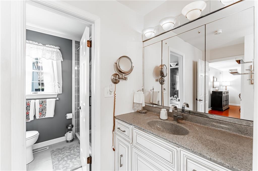199 Roscommon Place Canonsburg, PA 15317 - Photo 10 of 32 a bathroom with a granite countertop sink a toilet and a mirror