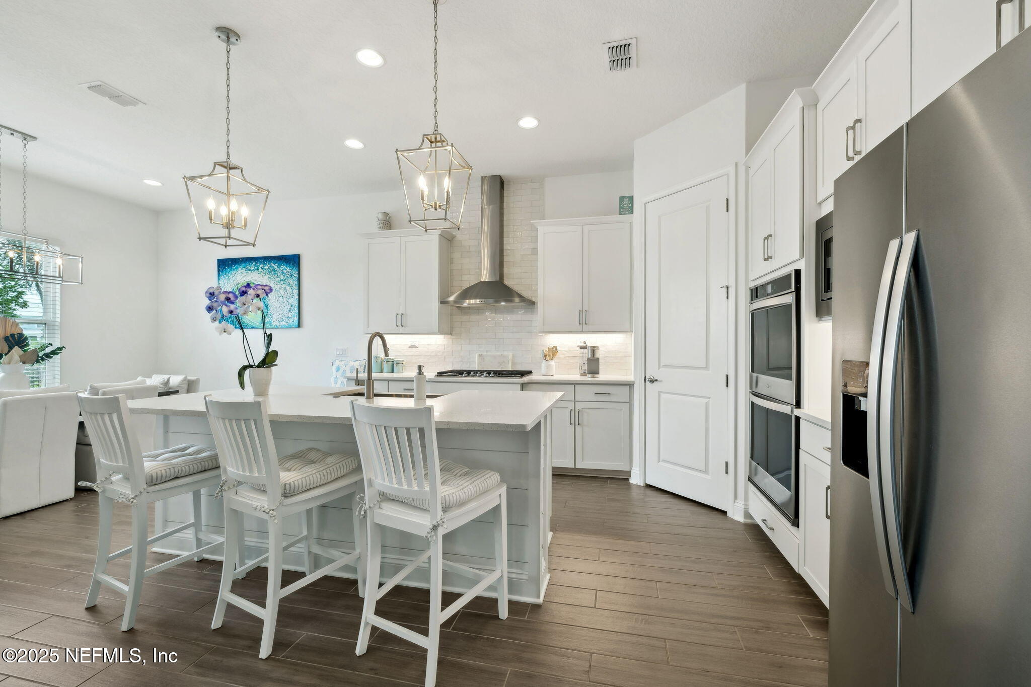 560 Rum Runner Way St. Johns, FL 32259 - Photo 13 of 101 a kitchen with kitchen island wooden floor center island and stainless steel appliances