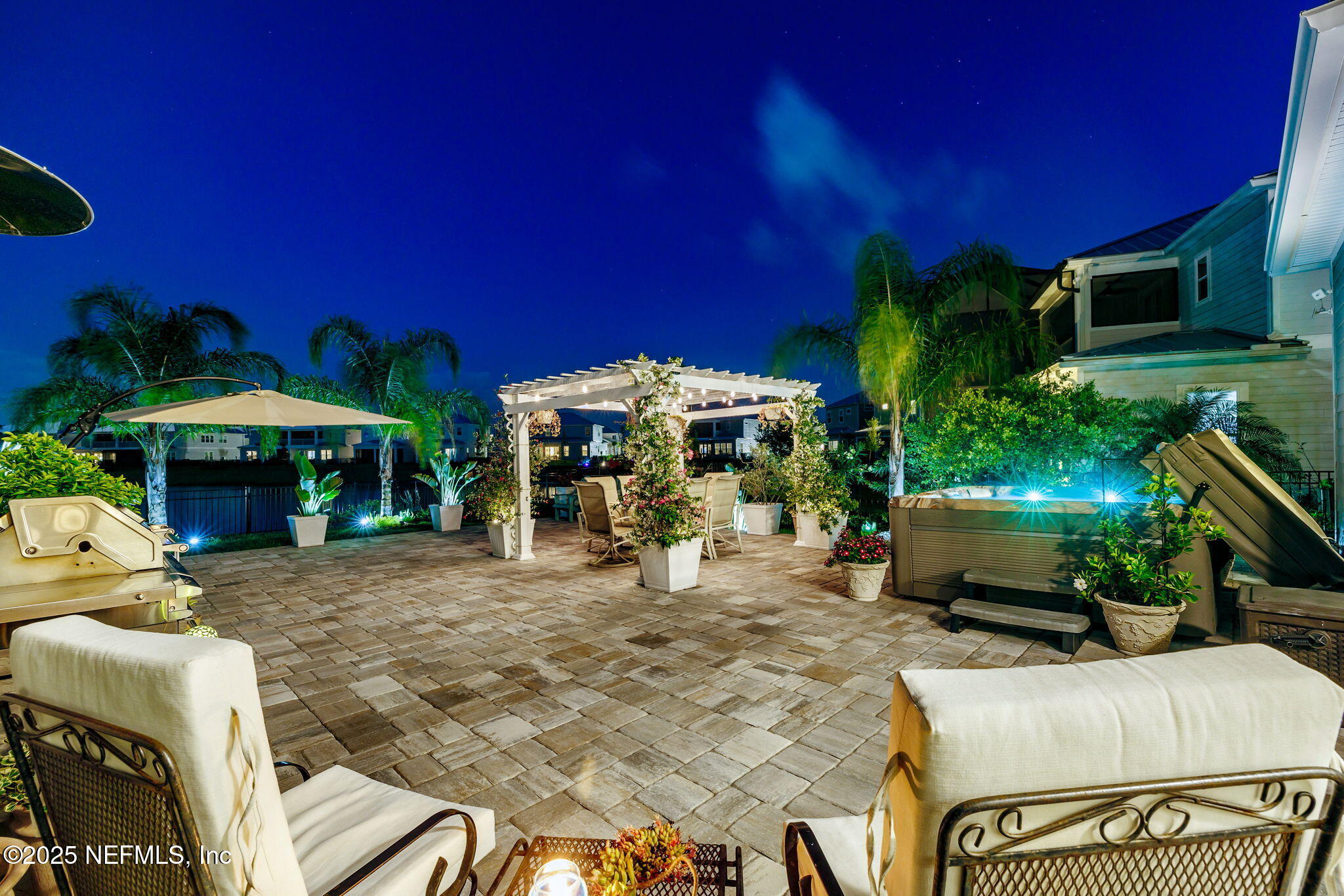 560 Rum Runner Way St. Johns, FL 32259 - Photo 49 of 101 a view of a patio with table and chairs under an umbrella