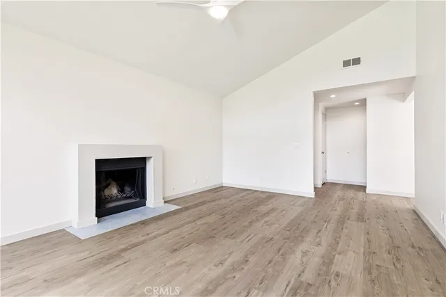 a view of an empty room with wooden floor