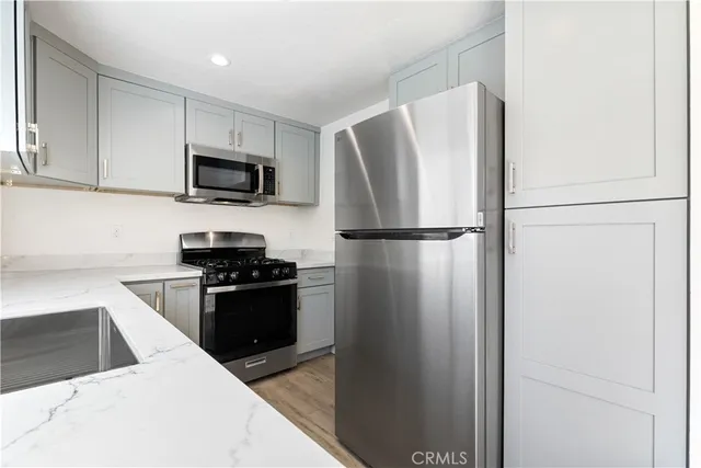 a kitchen with stainless steel appliances a stove and a microwave