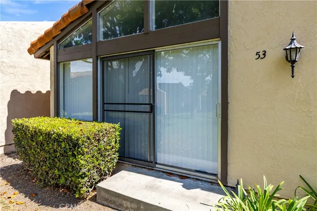 an aerial view of a house with garden space and street view