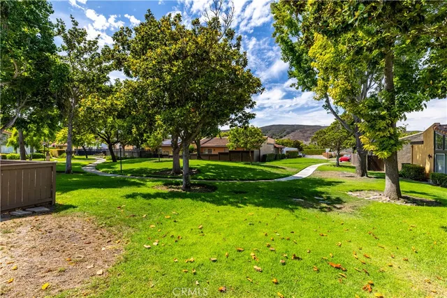 an aerial view of residential houses with outdoor space and street view