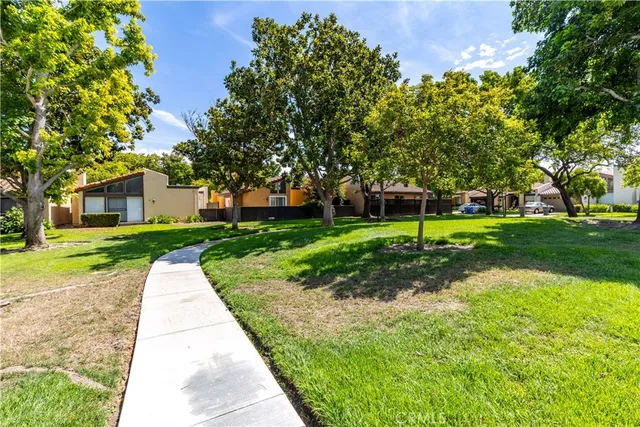 an aerial view of a city with lots of residential buildings and mountain view in back