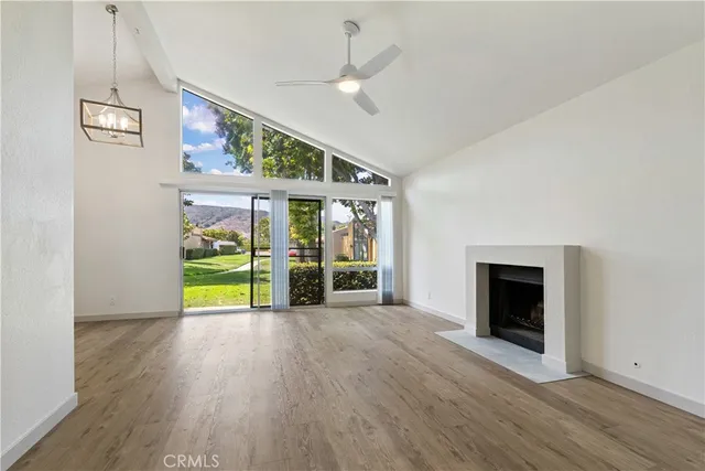 an empty room with windows and outdoor view