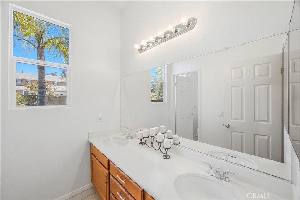 8710 Windmill Place Riverside, CA 92508 - Photo 32 of 66 a bathroom with a sink and a mirror