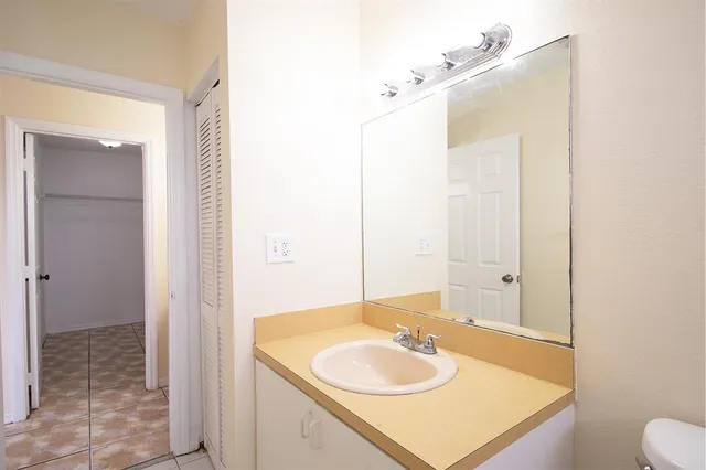 a view of a bathroom from a corridor