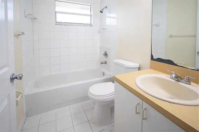 a bathroom with a sink a toilet and mirror