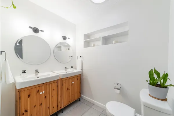 a bathroom with a toilet sink and mirror