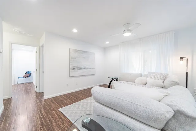 a kitchen with stainless steel appliances granite countertop a lot of counter space and wooden floors