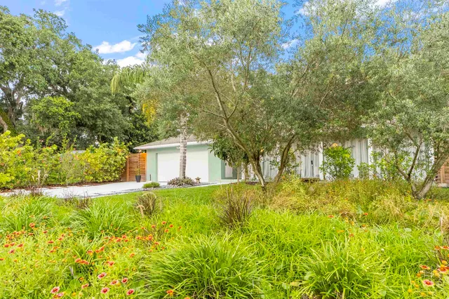 a view of a porch with furniture and garden