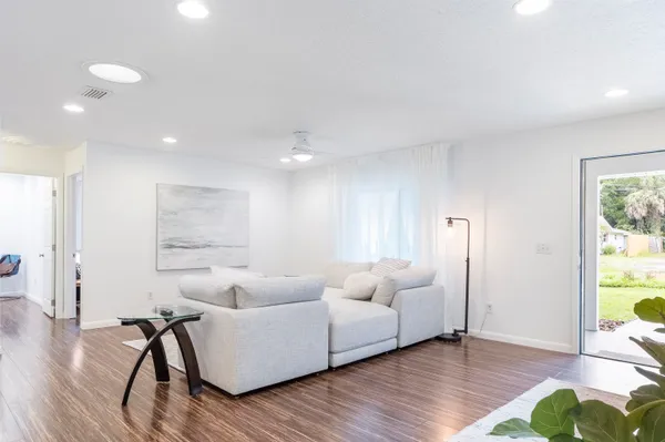 a kitchen with stainless steel appliances granite countertop a lot of counter space and wooden floors