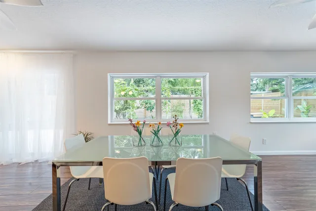 a view of a hallway with wooden floor and entryway