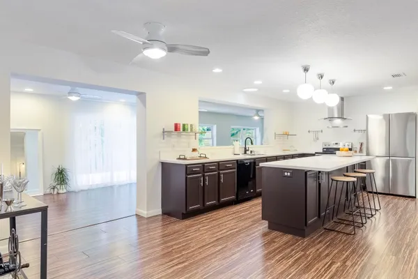 a large kitchen with a large counter top table and chairs