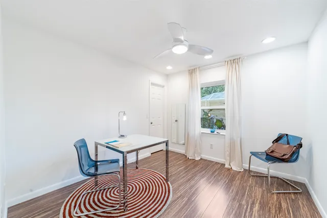 an aerial view of residential houses with outdoor space and trees