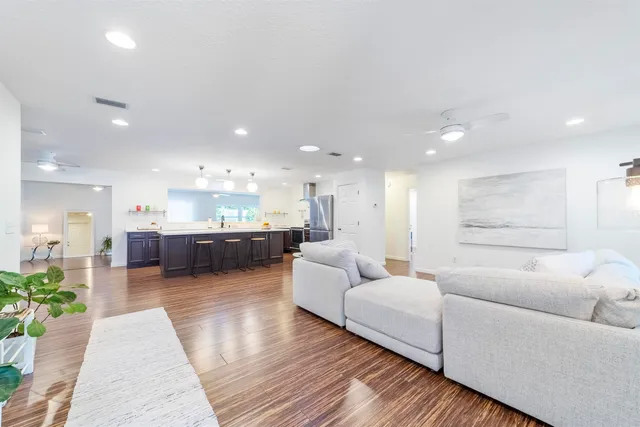 a living room with furniture and kitchen view