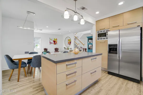 a kitchen with cabinets and stainless steel appliances